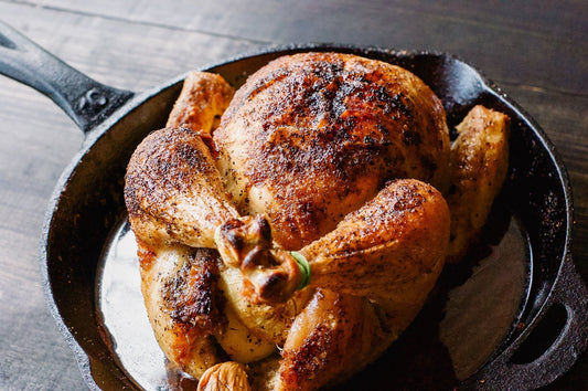 Golden roast chicken in a cast iron pan