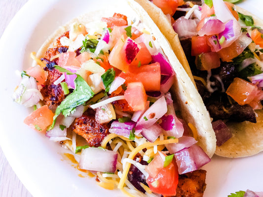 gorgeous shrimp tacos on a serving tray with salsa and chips