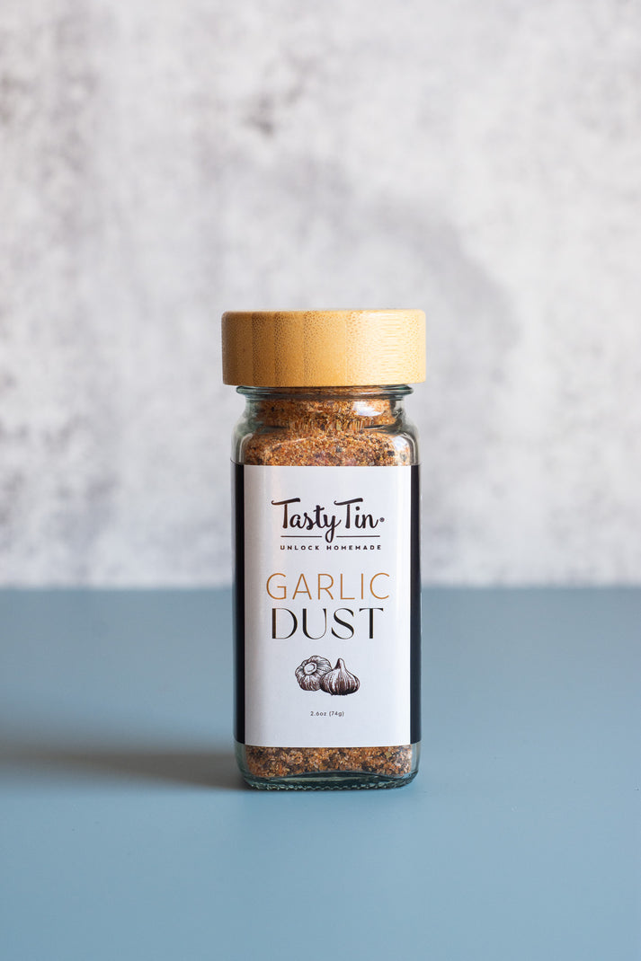 Garlic Dust All Purpose Seasoning Shaker Jar by Tasty Tin — an artisan spice blend in a glass shaker with bamboo lid, made by a Black woman-owned business in Minneapolis