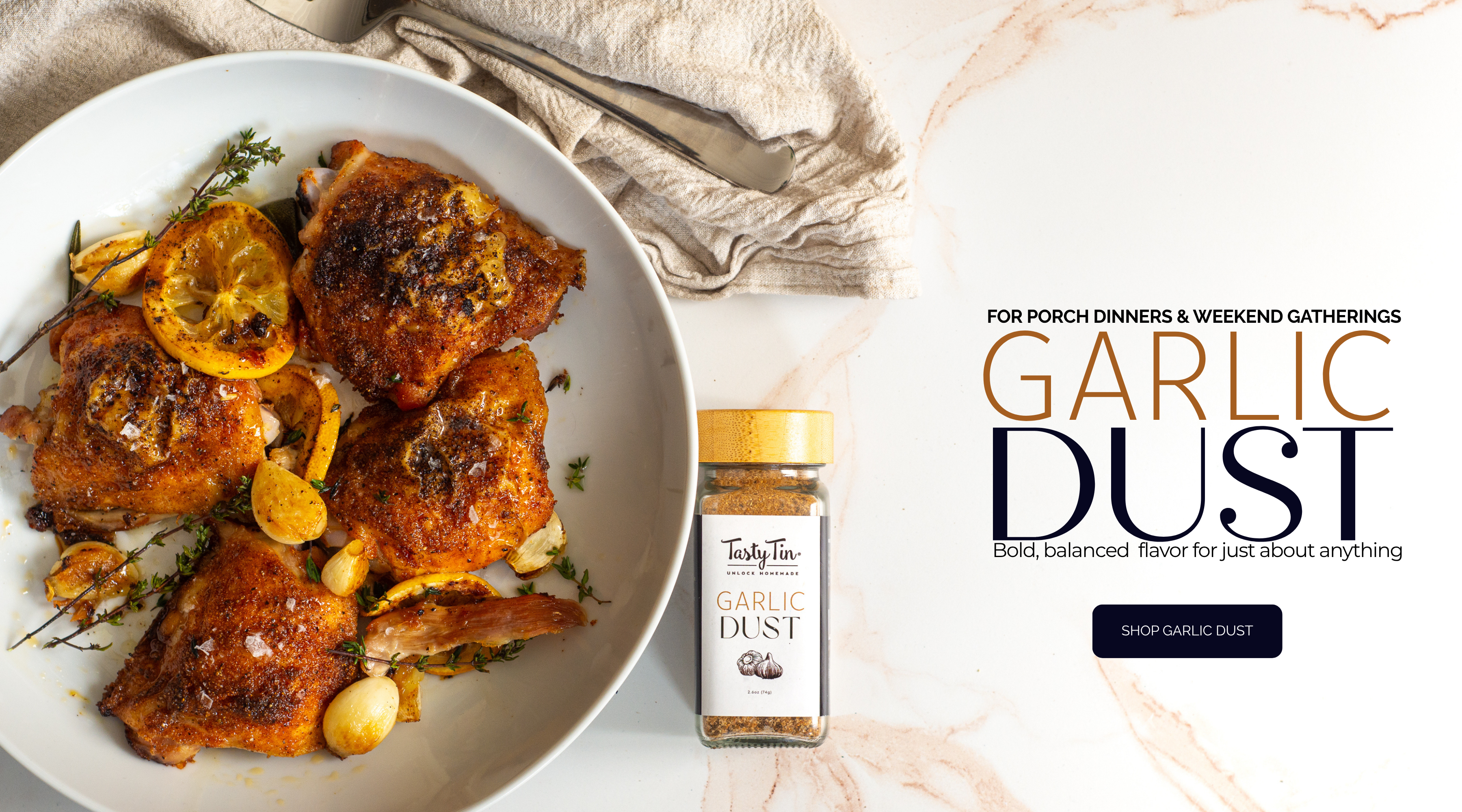 Garlic dust container with roasted chicken dish on a plate