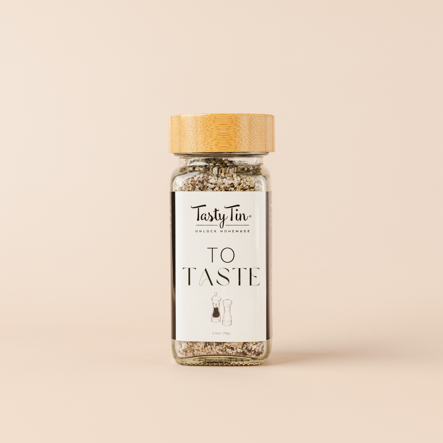 Tasty Tin gourmet seasoning shaker with bamboo lid and clear glass bottle displaying seasoning blend