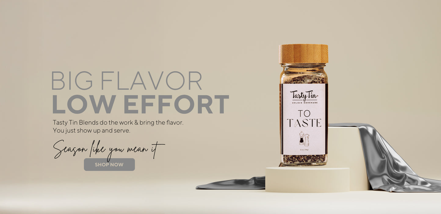 Tasty Tin gourmet seasoning shaker with bamboo lid on display with minimal background and promotional text