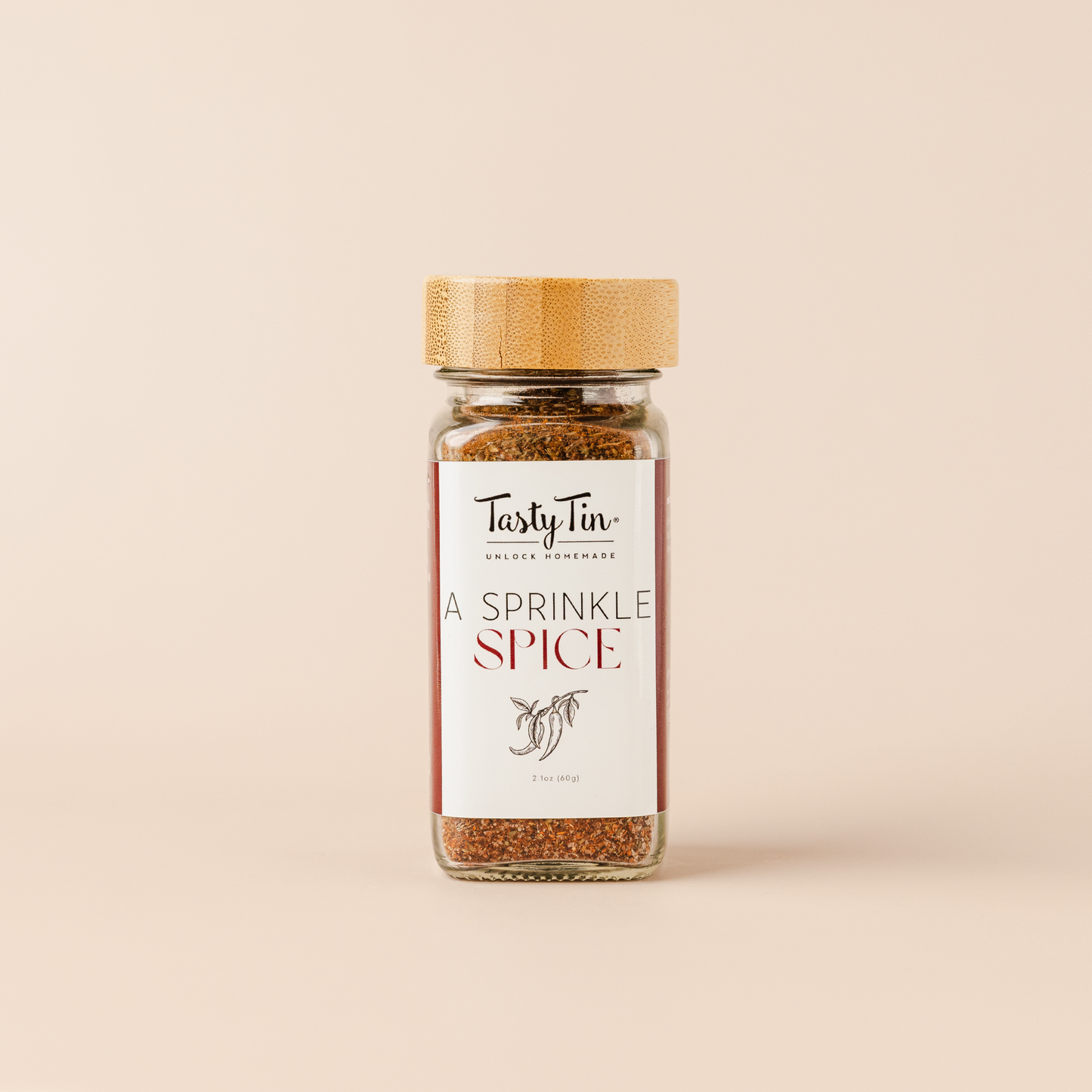 Tasty Tin A Sprinkle Spice seasoning in a glass gourmet spice shaker with bamboo lid