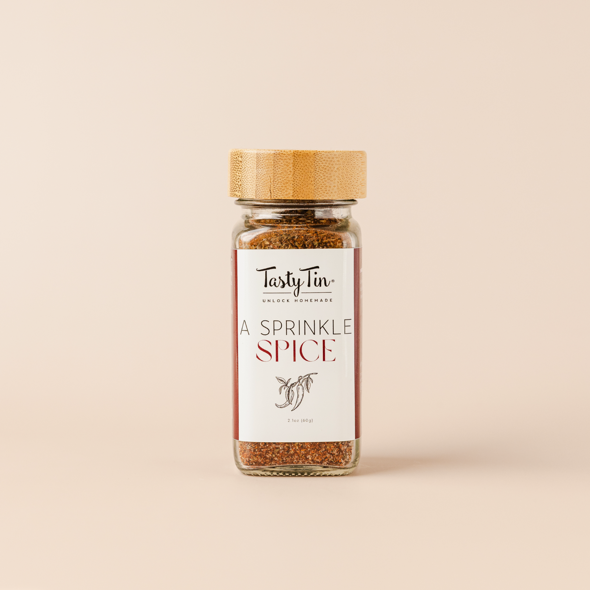 Tasty Tin A Sprinkle Spice seasoning in a glass gourmet spice shaker with bamboo lid