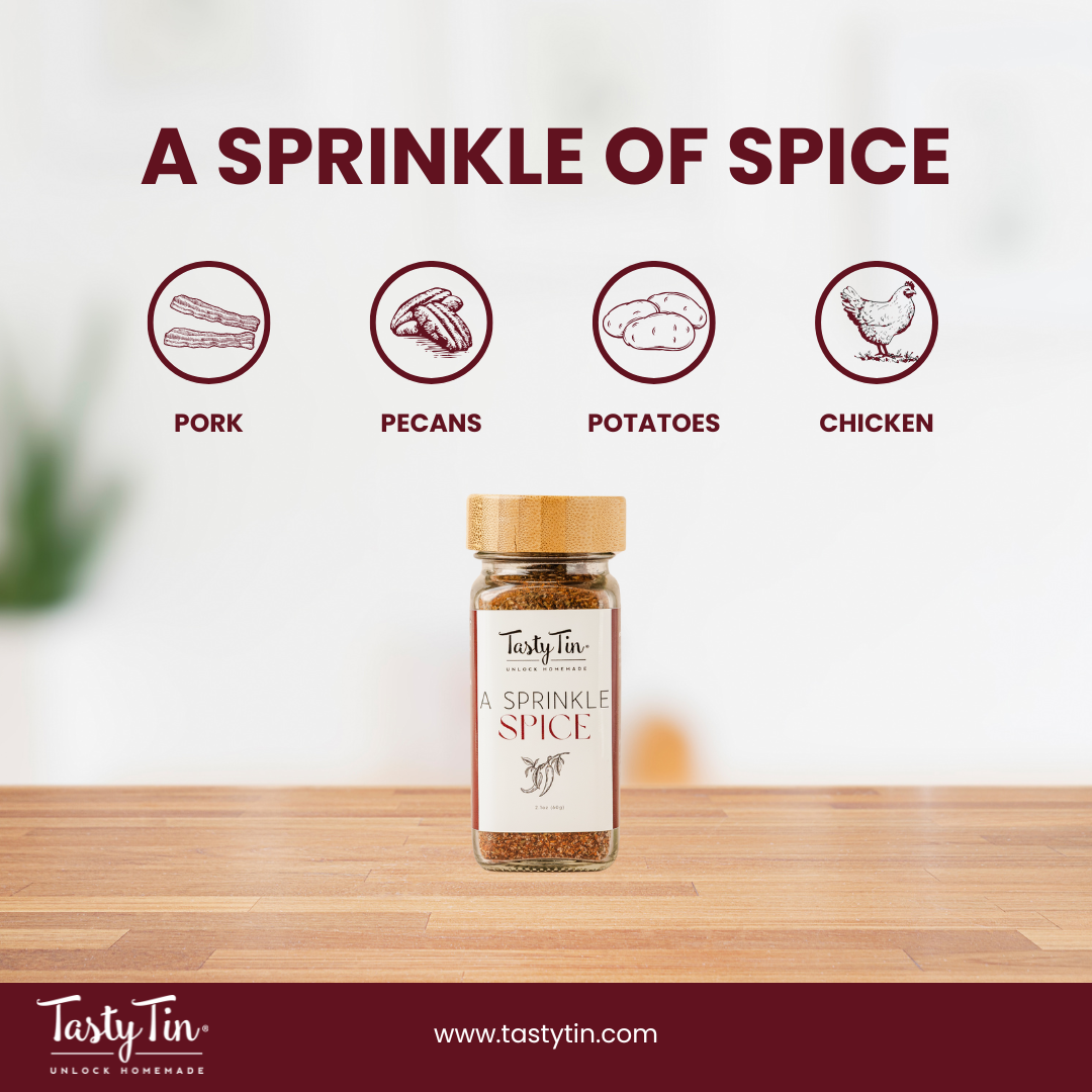Tasty Tin gourmet spice shaker labeled A Sprinkle of Spice on wooden surface with food icons